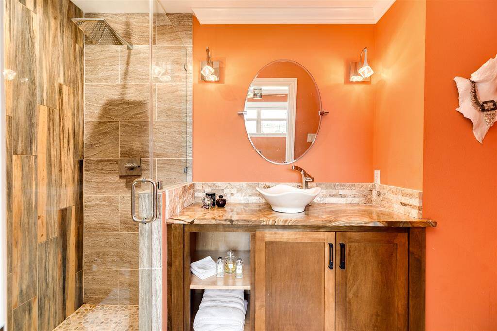 Guest bathroom features a high-end granite counter top & vessel sink. An oversized rain shower head is like being in a spa. All shower heads have been replaced with high-end fixtures.