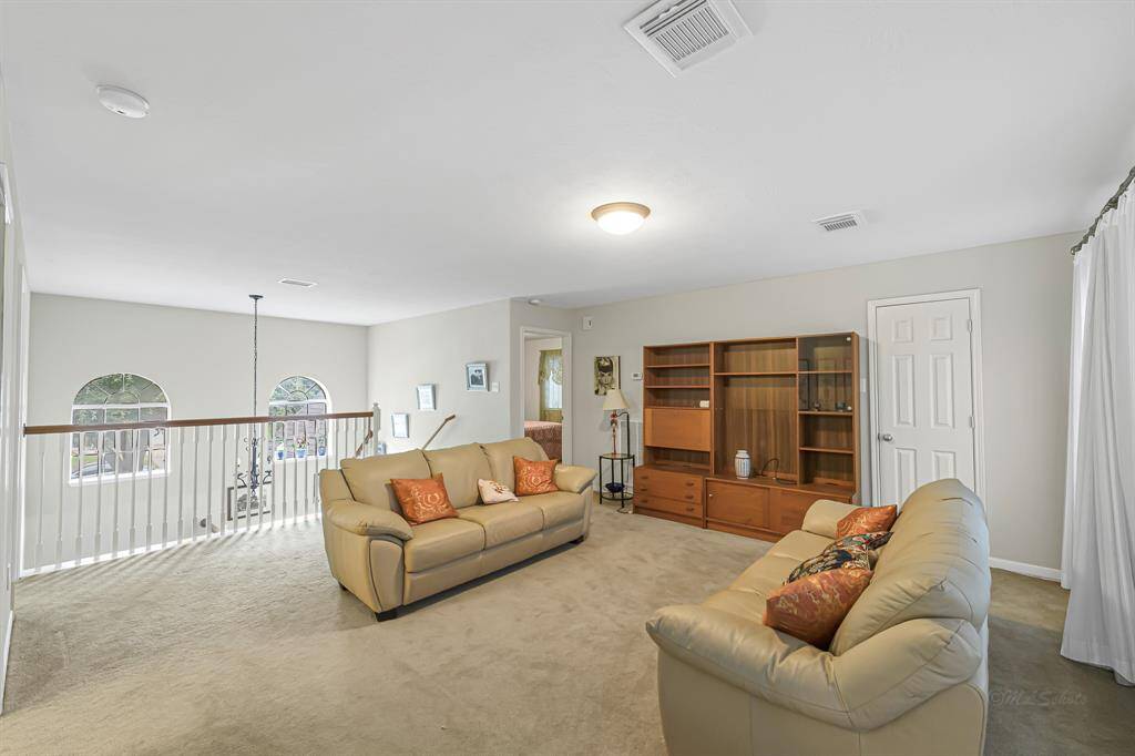 The upstairs game room offers a versatile space that can be used for entertainment, relaxation, and family bonding. Features include plush carpet and decorator paint!
