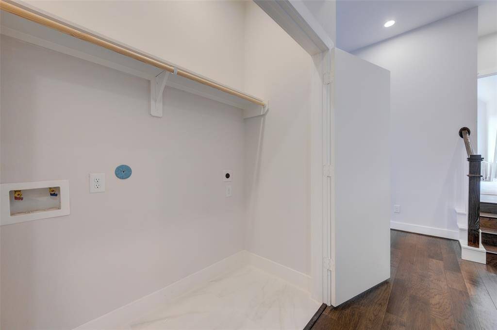 This conveniently located laundry nook offers ample space for your washer and dryer, with additional shelving for storage. The clean, bright design ensures a pleasant and efficient laundry experience.