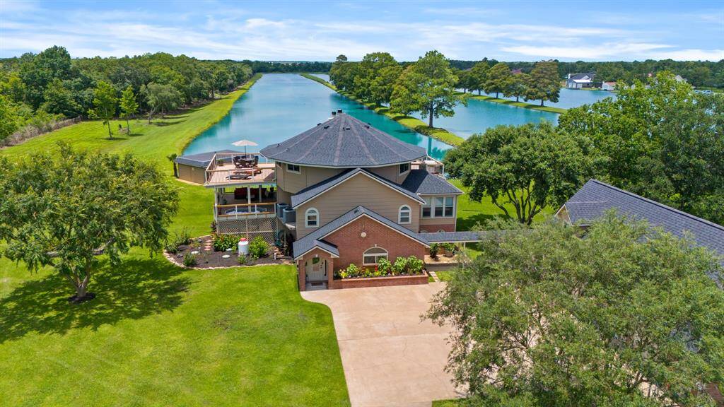 Wow! This Home has So Many Features! Private LAKEFRONT .76 Acre Lot, 3700+SqFt Main Home, 4 Car Garage with 2 Upstairs Garage Apartments.