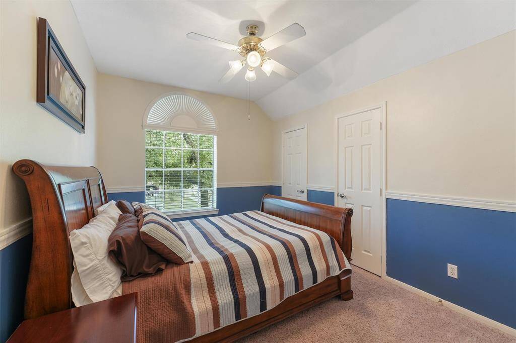 This is a cozy 2nd bedroom with arched windows.