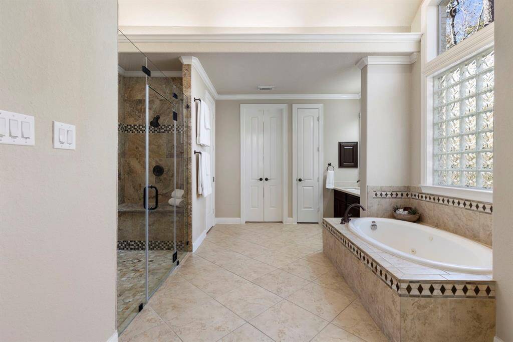 Another view of the primary bathroom showcases a stunning dome ceiling accent, adding a touch of architectural elegance to this luxurious space.
