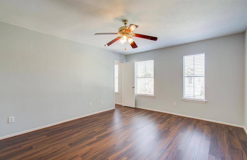 Another view of Primary bedroom featuring the two windows that provide ample natural light, creating a welcoming atmosphere.