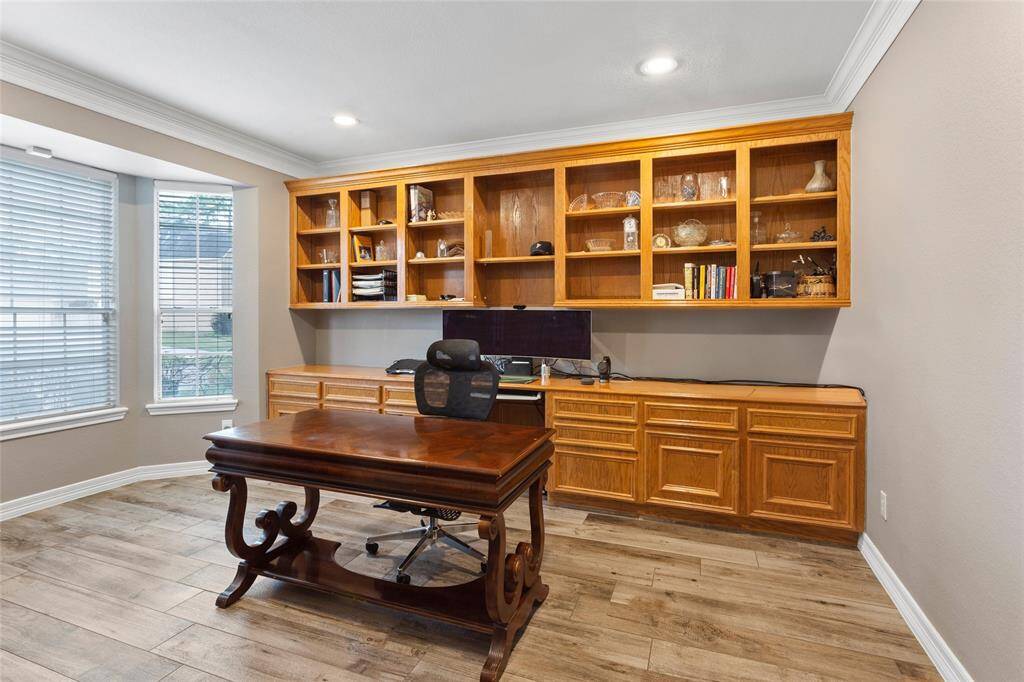 Huge office off the entry with tons of solid wood built in cabinets.