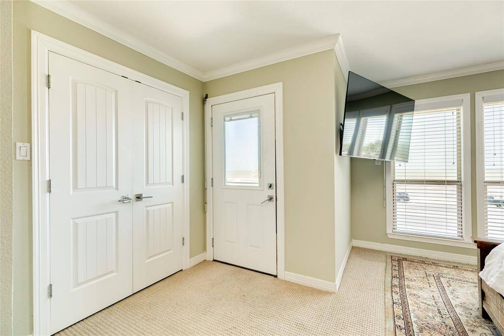 One of 2 large closets in the primary bedroom. The door to the right opens up to your private balcony
