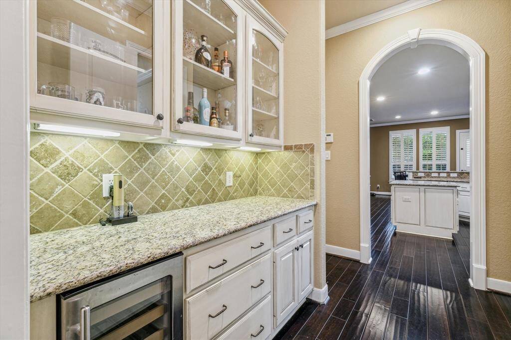 Butler's pantry area looking into the kitchen. The glass cabinetry is the perfect spot for all your nice dishes!