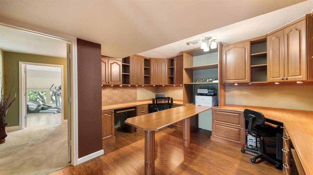 Designated Home Office just steps from the Owner's Primary Suite. Tons of Built-Ins, Counter Space & Desk to spread out and get work done.