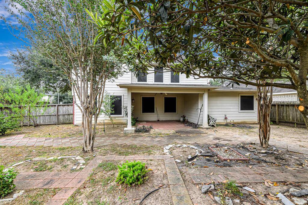 Step outside to find a fabulous placeto relax and unwind under your covered patio with a ceiling fan and a view of the large backyard!