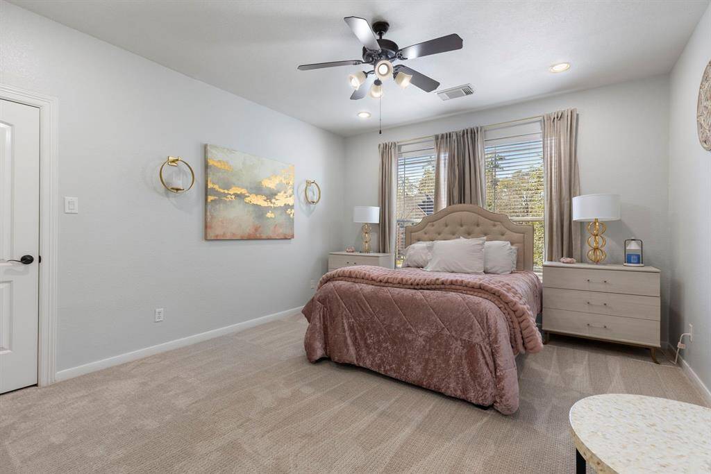 This very spacious secondary bedroom is filled with natural light, creating a bright and inviting space.