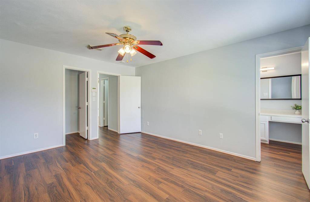 Another view of Primary bedroom featuring an en-suite bathroom and a walk-in closet.