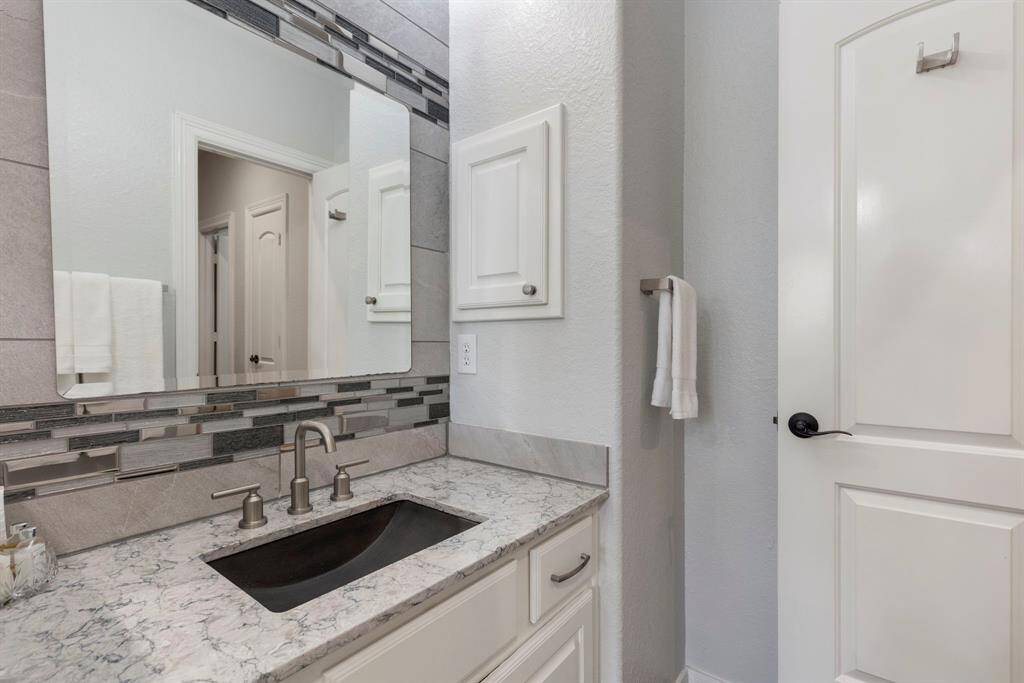 The Jack and Jill bathroom has been beautifully updated with modern finishes and sleek hardware, combining style and functionality.