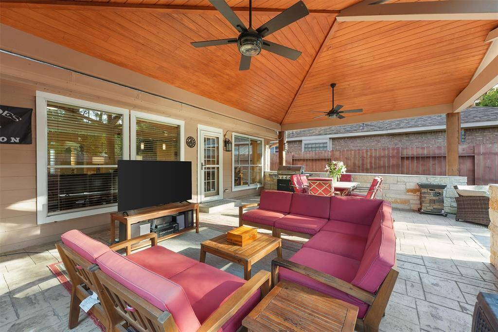 Another photo of the  spacious covered patio with a comfortable outdoor seating area and an area for  grilling. Perfect for entertaining and relaxation.