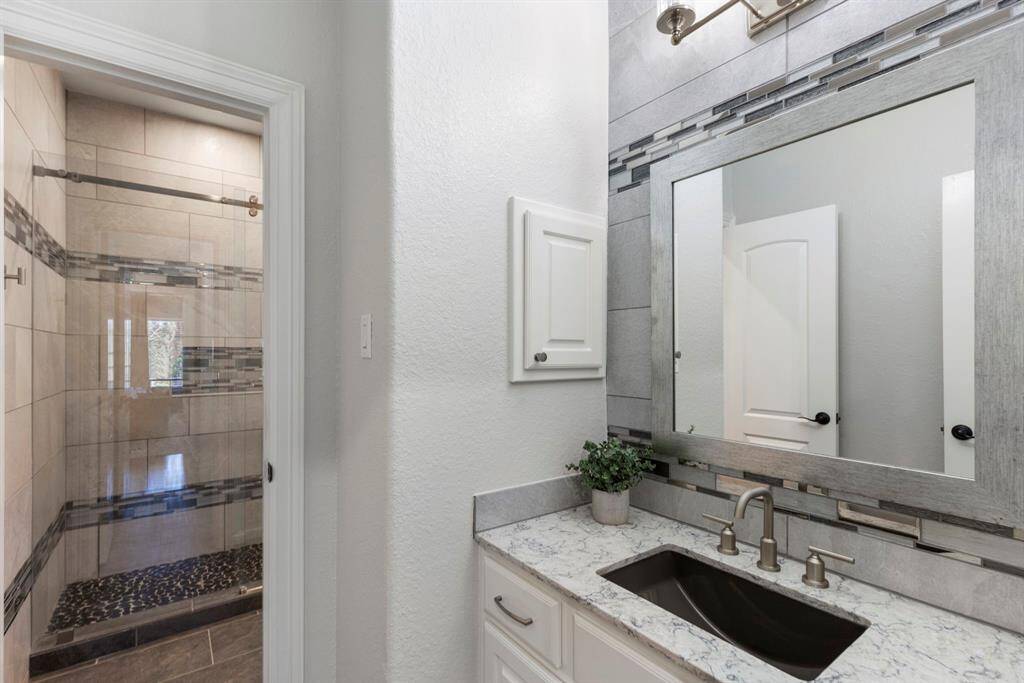 This Jack and Jill bathroom serves both the secondary bedrooms and the game room, offering convenient access for guests while maintaining privacy and functionality.