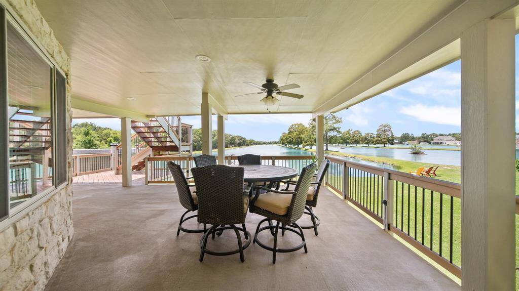 2nd Floor Covered Deck just off the Sunroom. Ceiling Fan for a Breeze & Shady Lounging Spot to Enjoy the Beautiful Blue LAKES.