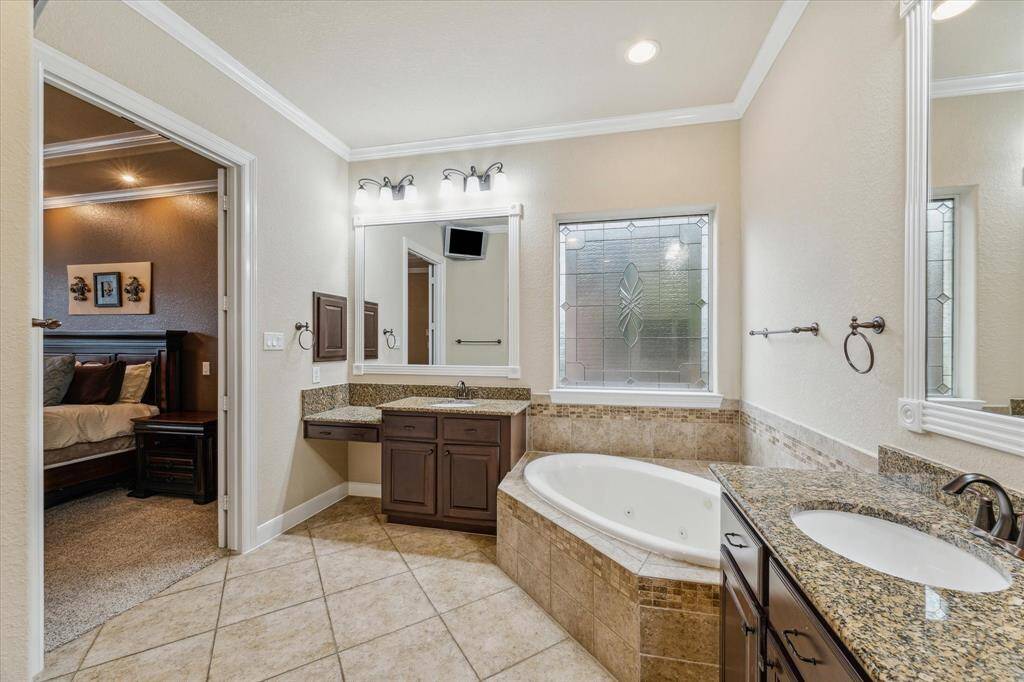 Dual sinks and vanity area in the primary suite!