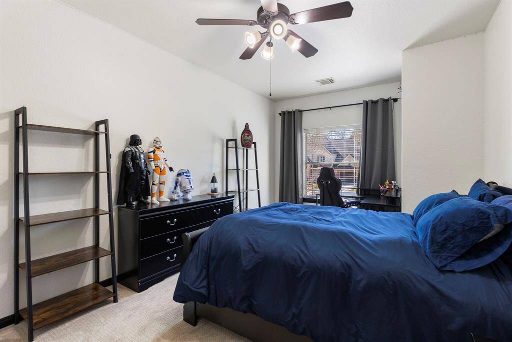 In the closet of this secondary bedroom, you'll find a large built-out attic space, ideal for storing seasonal items and keeping your home organized.