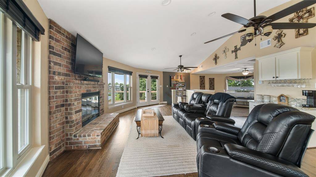 Family Room has a Cozy, Gas Fireplace with Brick Surround. There is a High Ceiling with 2 Ceiling Fans for a Cool Breeze. Whatever Season, this Room will make sure you're comfortable.