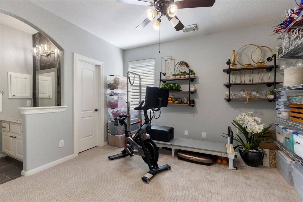This secondary bedroom is currently utilized as a workout and storage room, offering versatile space that can easily be adapted to suit your needs.
