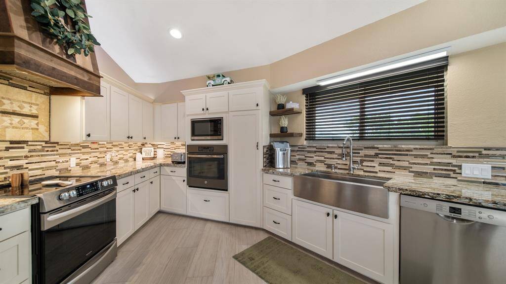 Kitchen Remodeled August 2023 with Custom Cabinetry & Granite Counters. Notice the Gorgeous Vent Hood!