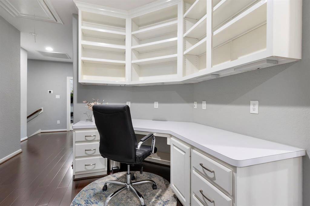 As you walk up the stairs, you'll find a built-in work area that offers convenient storage for books and other supplies, adding both functionality and organization to the upper level.