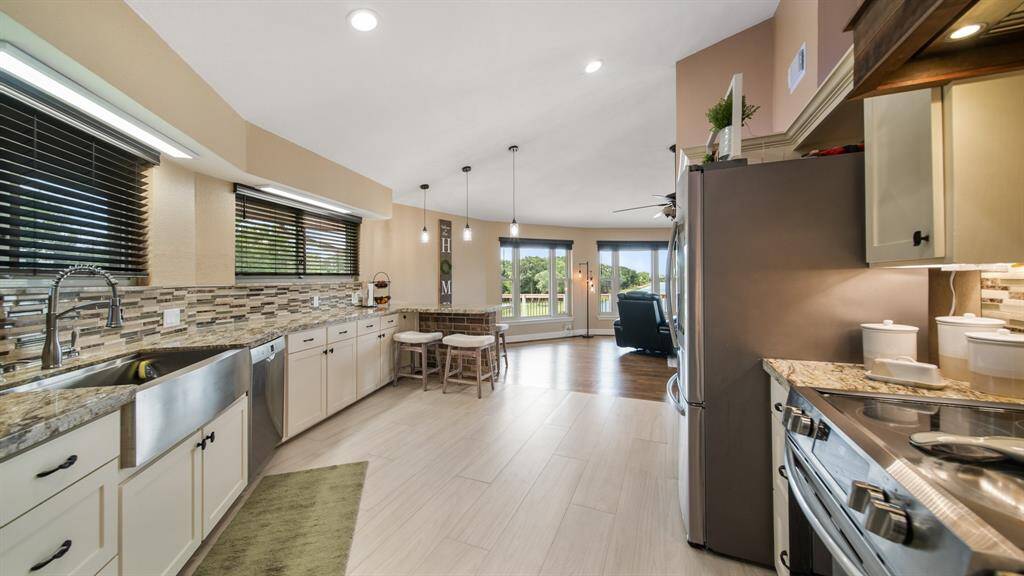 Kitchen has a Deep Apron Front Stainless Sink & Large Windows with a View. Whole Home Water Filtration System installed 2019.