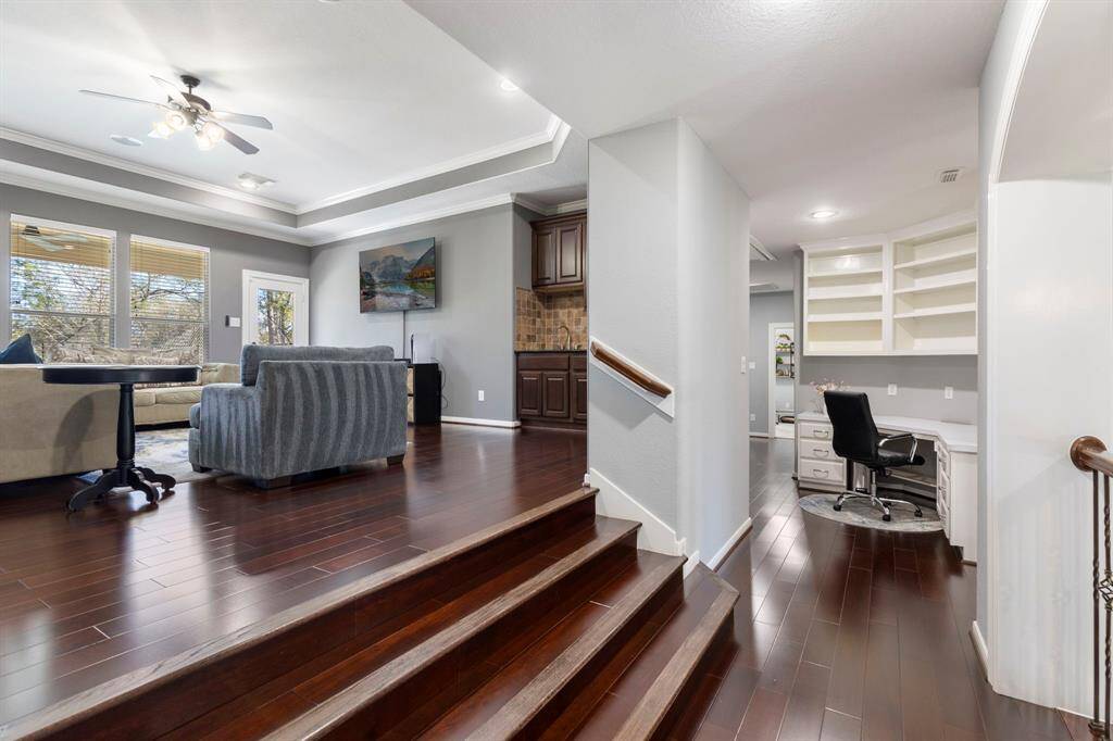 Get ready for family fun! This extra-large game room is perfect for entertaining, featuring plenty of space for a pool table or other gaming options. It also includes a wet bar and cabinet storage, adding convenience and style for hosting memorable gatherings.