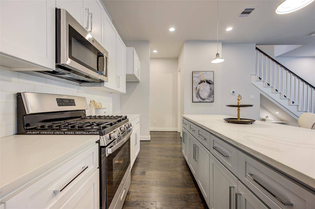Equipped with top-of-the-line stainless steel appliances and sleek cabinetry, this kitchen combines functionality with modern aesthetics. The spacious layout and high-end finishes make it an ideal space for culinary creativity and hosting dinner parties, ensuring that every meal preparation is a pleasure.