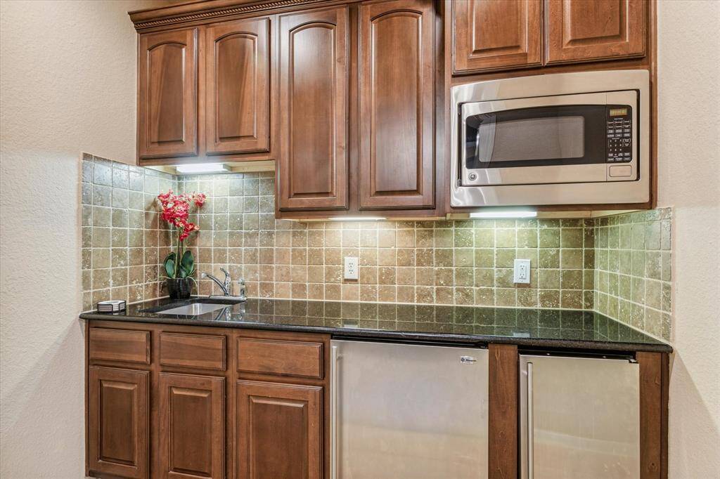 Wet bar area upstairs with a sink, separate ice maker, mini fridge and microwave!
