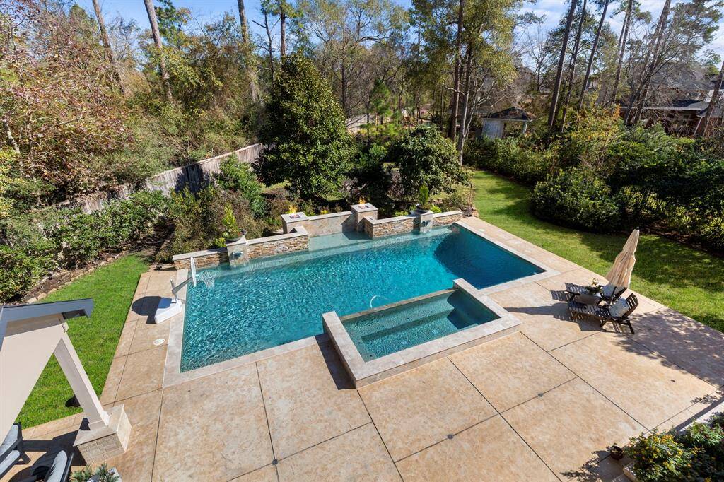 Enjoy a great view of the expansive, lush, and private backyard space from the balcony. This rare find in The Woodlands offers unparalleled privacy and a serene setting, making it truly one-of-a-kind.