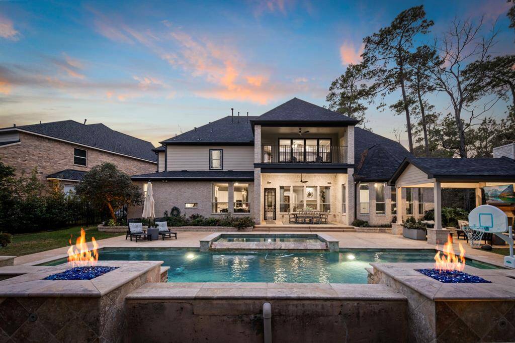 This backyard at twilight is a dream come true! The water and fire features create a stunning ambiance, making it the perfect setting for evening relaxation or entertaining.