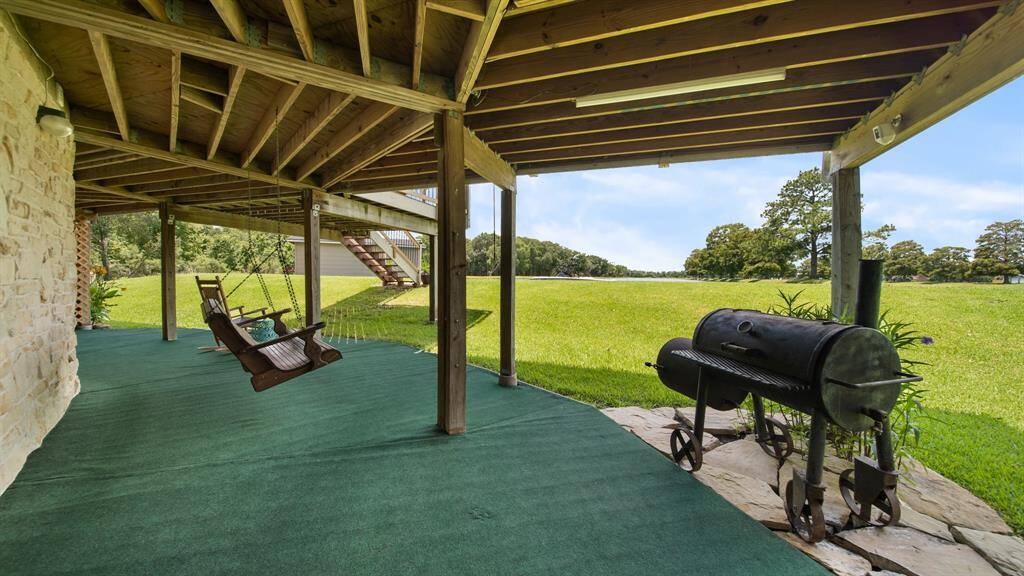 Sit A While - This 1st Floor Covered Patio is Perfect for Rainy Days & Shaded Outdoor Entertaining. Notice your Private Boat House in the Center Background.