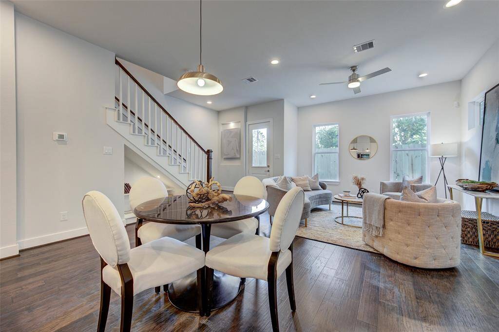 This dining area offers a perfect blend of style and comfort, designed for both intimate family dinners and larger gatherings. The open floor plan allows for easy movement between the dining and living spaces, creating an inviting atmosphere for socializing and relaxation. The contemporary furnishings and elegant decor enhance the home's modern appeal.