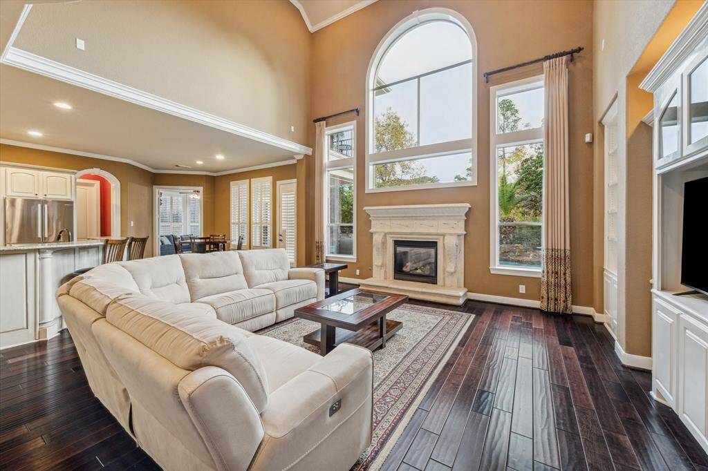 Cozy living room with gas fireplace and abundant natural light.