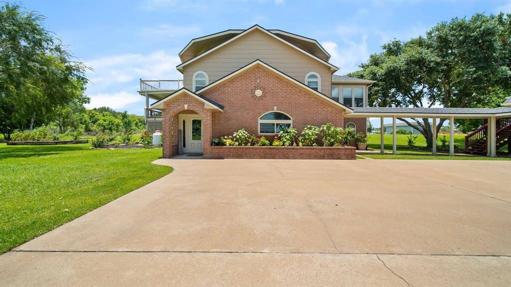 My Front Door faces East. There's plenty of Additional Concrete Parking for Guest. Covered Walkway to the 4 Car Detached Garage.