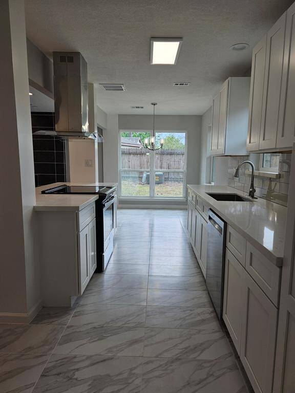 ewly remodeled kitchen with all new stainless steel appliances, cabinets, paint and counter tops
