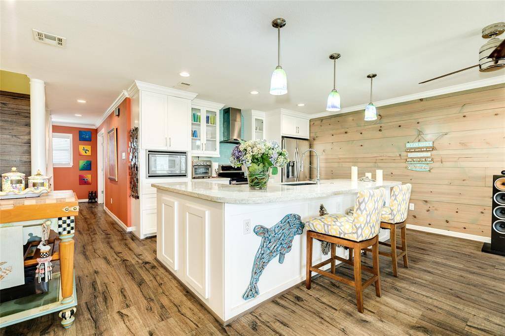 As part of an extensive remodel, the owners opened up the kitchen to the living room & built a huge L-shaped island