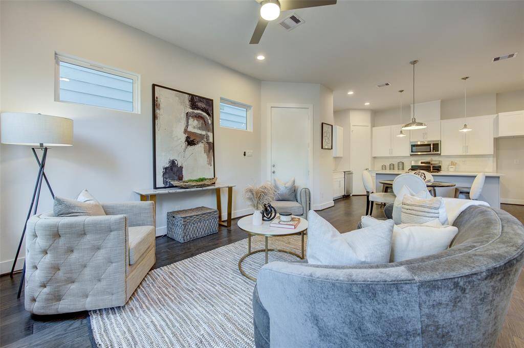 This living area is both chic and comfortable, offering a perfect space for relaxation and entertainment. The contemporary design, combined with cozy seating and stylish accents, creates a harmonious balance between luxury and comfort. The open layout ensures that this space is versatile and functional for any occasion.