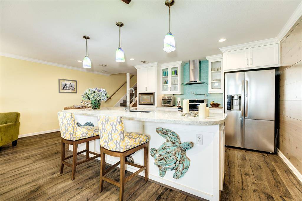 Island features a quartz counter top & single-basin sink