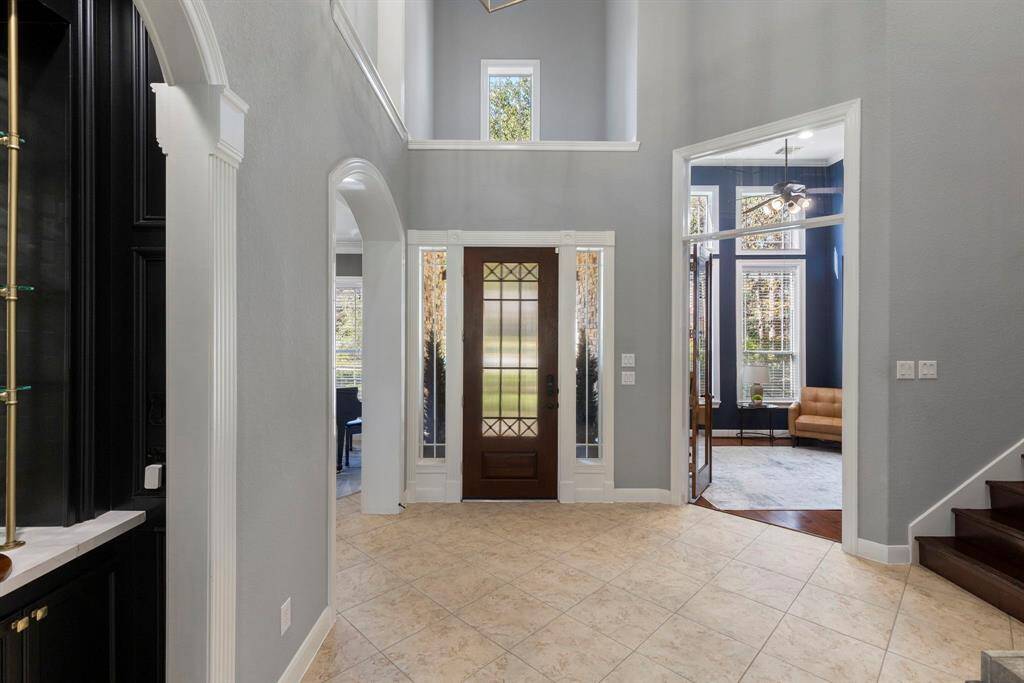A view from the foyer highlights the exquisite woodwork, adding warmth and character to the home’s entry and setting the tone for the rest of the beautifully crafted spaces.