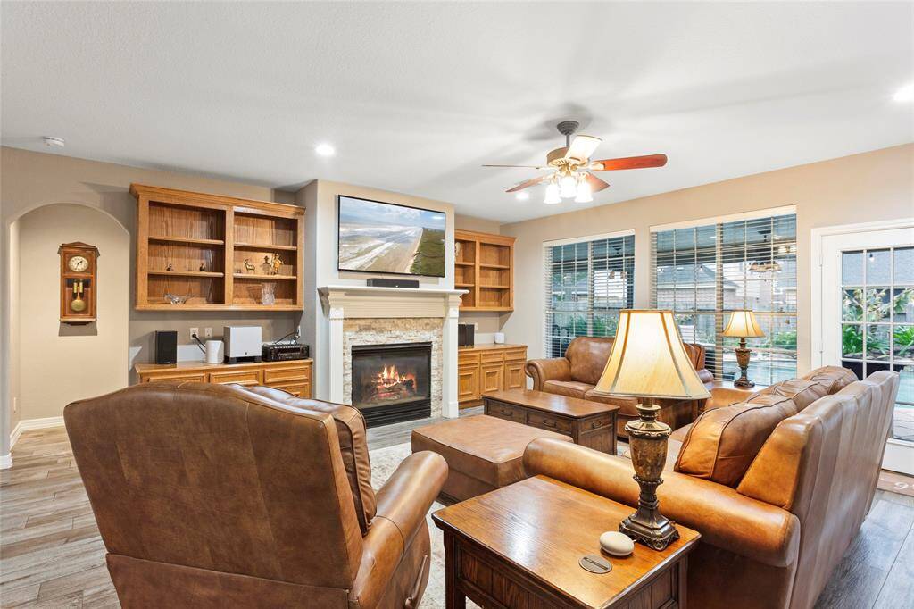 Family room with wood look tile flooring throughout the downstairs.