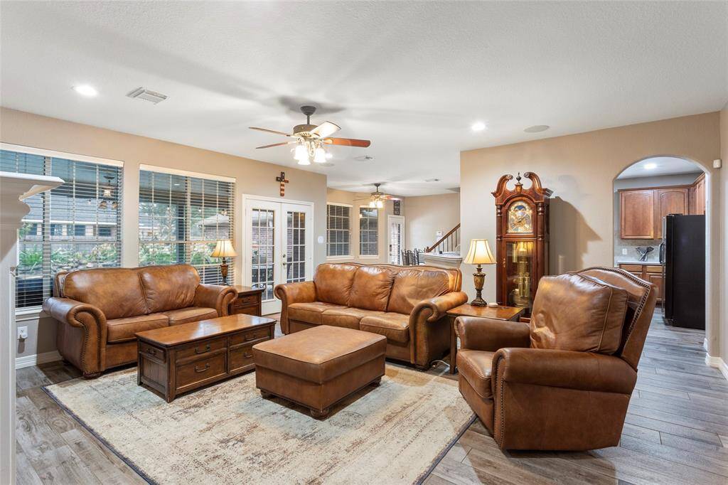 Double patio doors lead to covered patio and pool area.