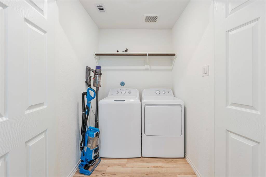 Across the hall is your large laundry room with a convenient hanging rack for your clothes.