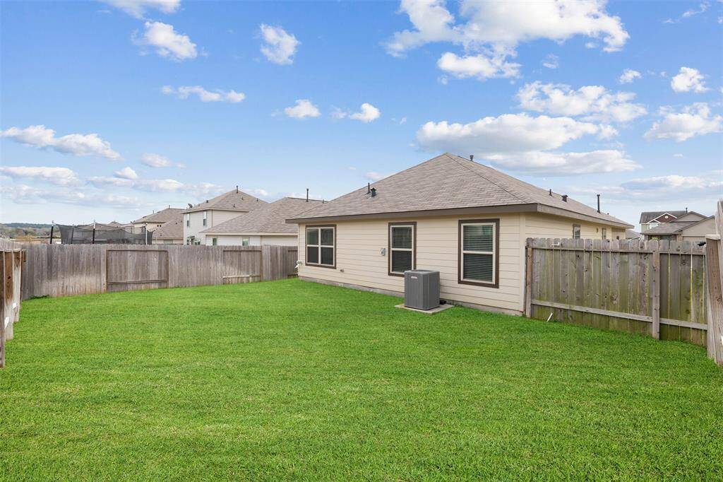 This backyard is spacious with lots of room for anything your heart desires.