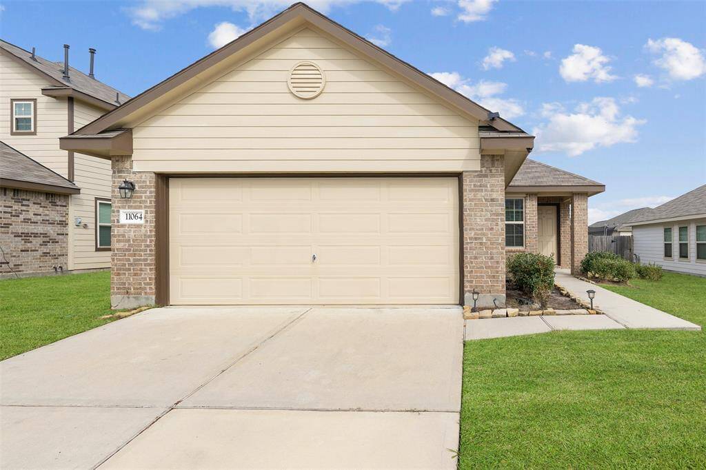 This home features a 2 car garage and space to park multiple vehicles in the driveway.