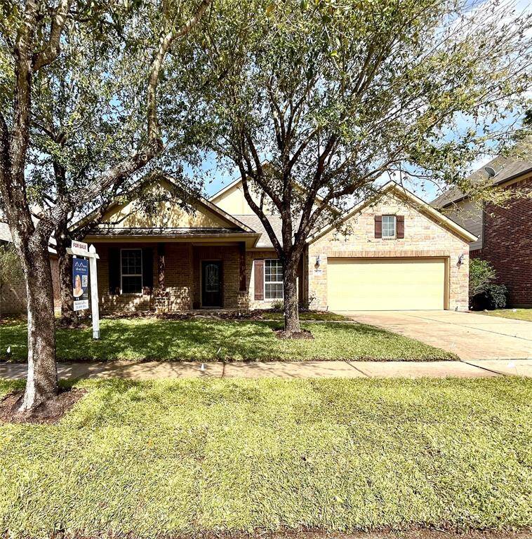 Welcome to your new home at 25209 Quiet Ledge. Beautiful brick and stone elevation and freshly laid sod create wonderful curb appeal.