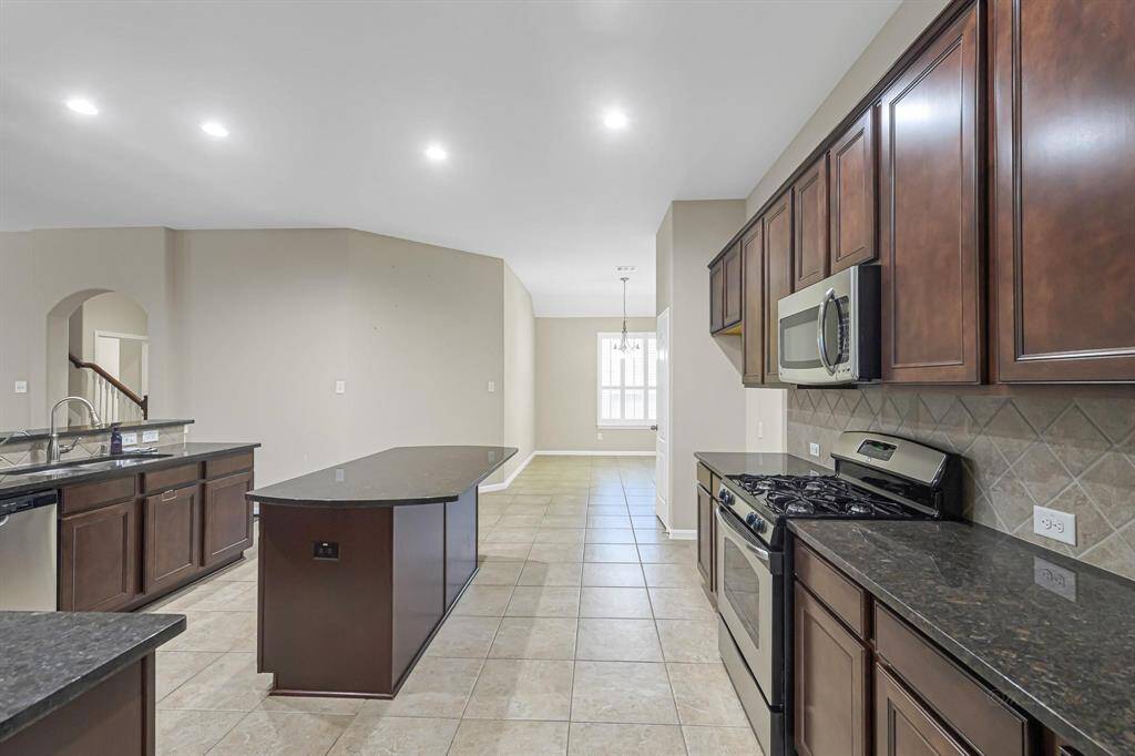 Kitchen offers plenty of counter space and cabinets. The chef of the family will appreciate the island as it is the perfect spot to prep meals.