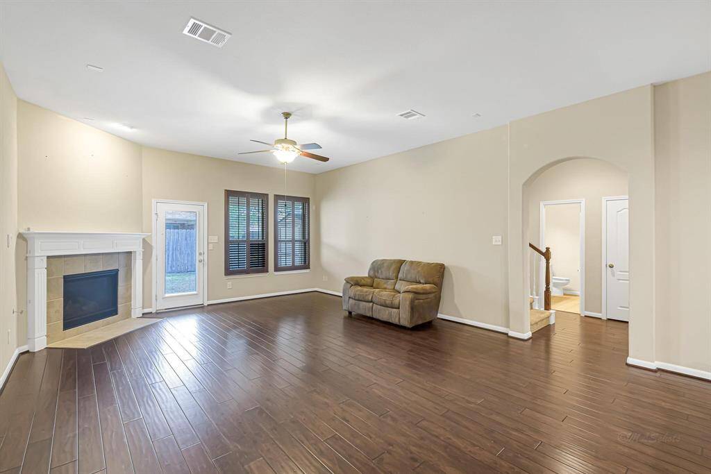 Wood floors made for easy clean up in this space. Door to the backyard and plantation shutters allow for lots of natural light as well.