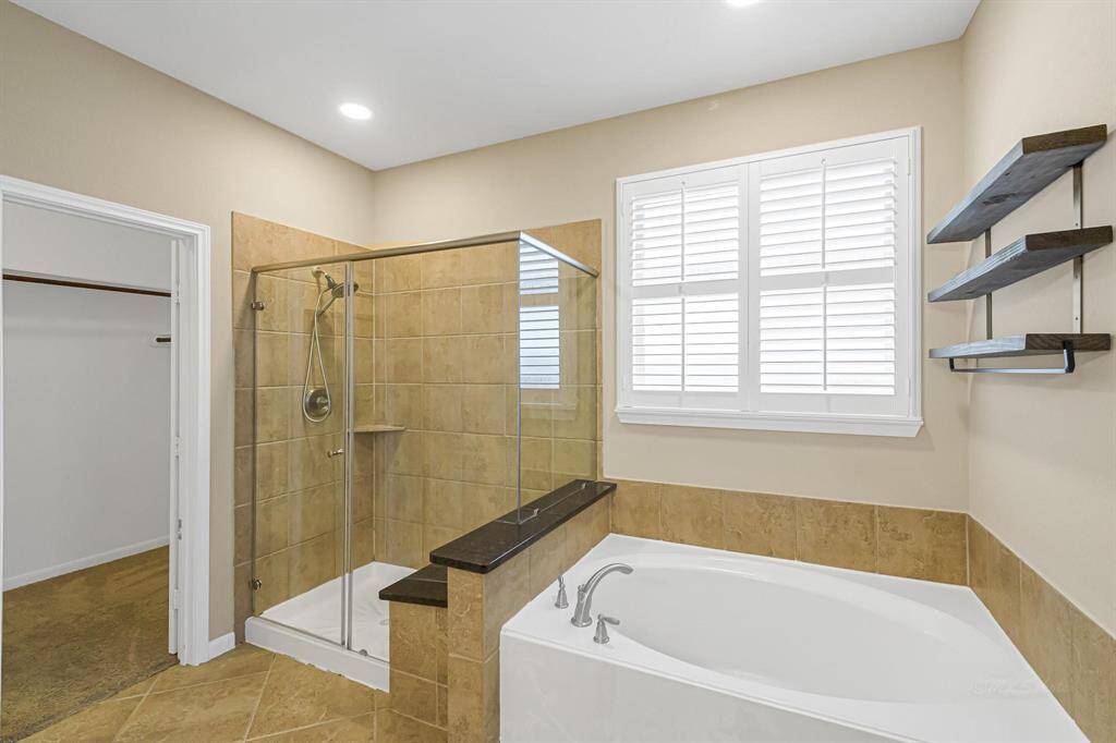 Garden tub is the ideal spot to soak your cares away after a long day. Separate oversized shower as well.