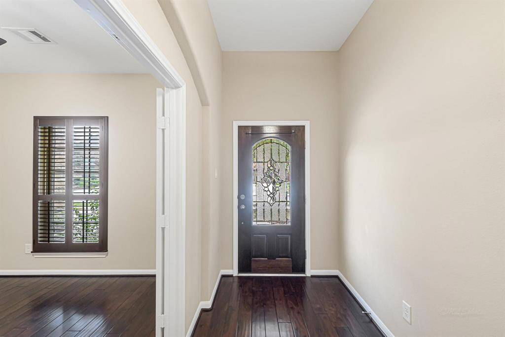 Lead glass front door provides privacy and a touch of elegance to the entry of this home.
