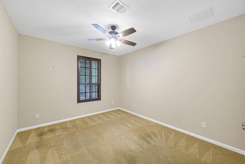 1 of the 3 secondary bedrooms of the home. As with the other bedrooms this one has a ceiling fan and custom plantation shutters